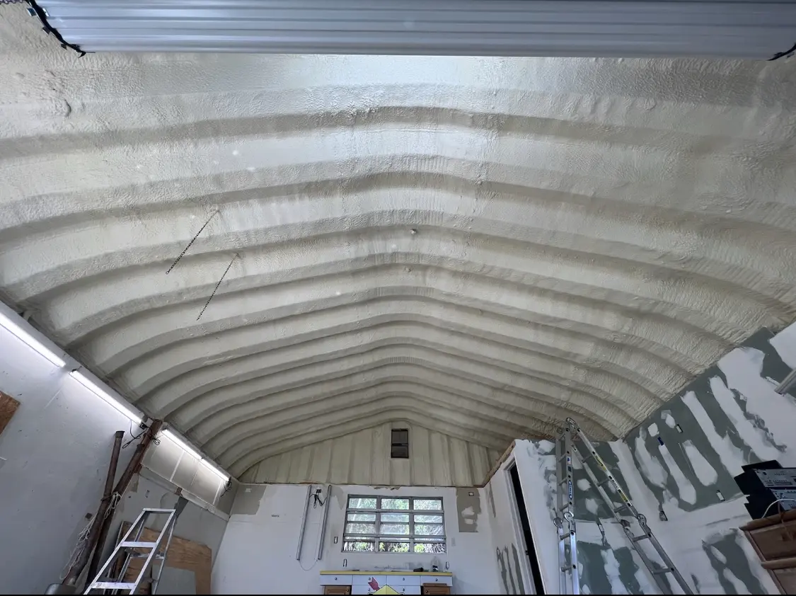 Spray polyurethane foam applied to the underside of a metal roof deck in Rogers